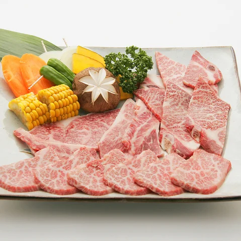 焼肉用の肉と野菜が大皿に盛り付けられた食卓